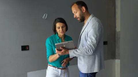Real estate agent talking to client and making deal at new home Stock Footage 105507263