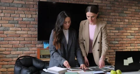 Real estate agents evaluating property blueprints in planning session Stock Footage 276569911