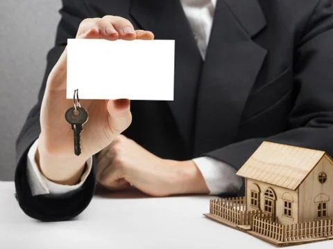 Real estate concept. Hands holding blank business card with keys 写真素材