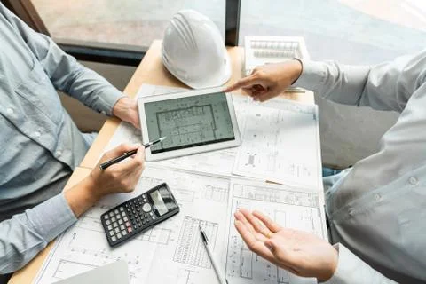 Real-estate concept, Two engineer and architect discussing blueprints data wo Stock Photos