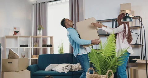 Real estate concept where handsome strong young african american holding carton Stock Footage 150697244