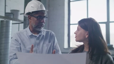 Real Estate Developer and Client Discussing Architectural Plan on Site Stock Footage 332249000