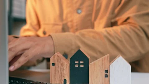 A real estate developer arranges wooden houses. Stock Footage 317600499