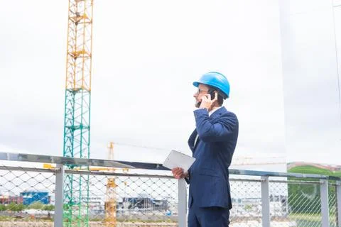 Real estate developer in helmet. New office construction. Confident business men Foto stock