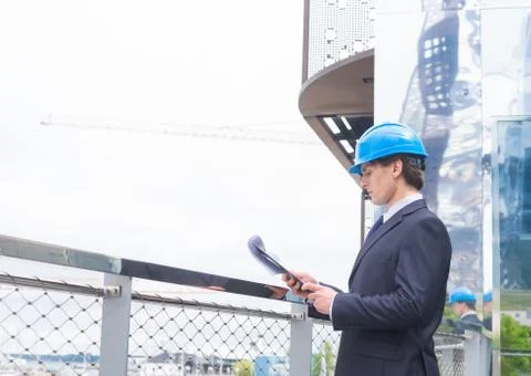 Real estate developer in helmet. New office construction. Confident business men Stock Photos
