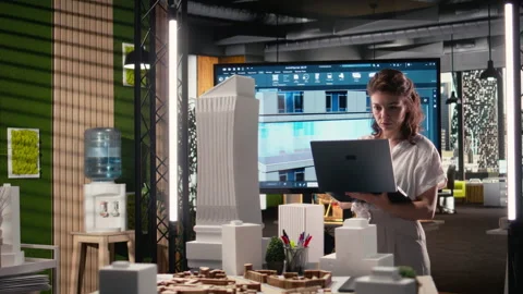 Real estate developer reviewing architectural blueprints and digital 3D models Stock Footage 316794803