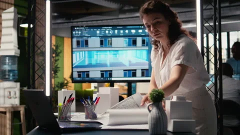 Real estate developer reviews master plan with construction layouts Stock Footage 316795455