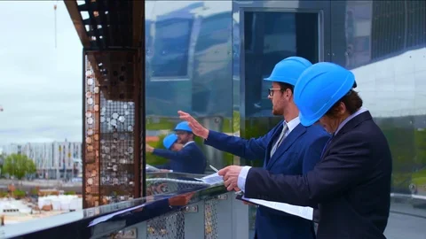 Real estate developers in helmets. New office construction. Confident business Stock Footage 112732293