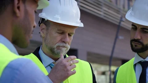 Real estate developers or technicians engineers looking upward in exterior Stock Footage 261342360