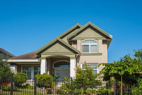 Real Estate Exterior Front House on a sunny day.Big custom made luxury hous.. Stock Photos