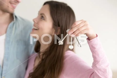 Real estate ownership concept, couple with keys to new home Stock Photos