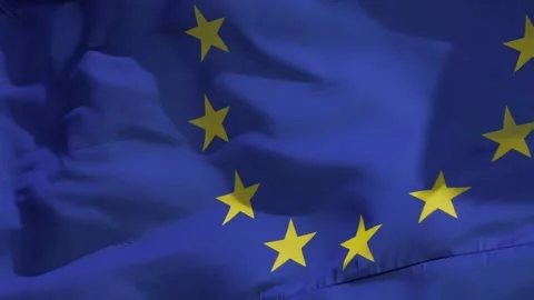 The real EU flag flies in the wind and symbolically disappears from the pictu Stockbeeldmateriaal 220933501