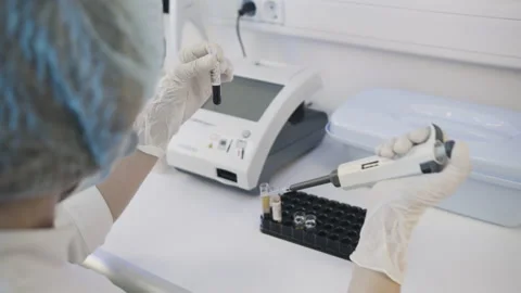 Real Female Medic Scientist Using Micropipette for Analysis Tube with Blood Video stock 229616051