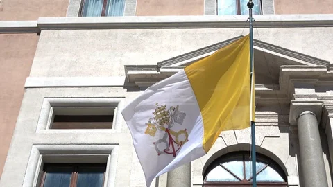 Real flag of the Vatican, waving in the wind on a balcony Stock Footage 104535744