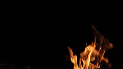 A real flame of fire with sparks burning on a black background. Stock Footage 142795475