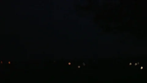 Real flashes of lightning over the cityscape during a powerful thunderstorm Stock Footage 115669155