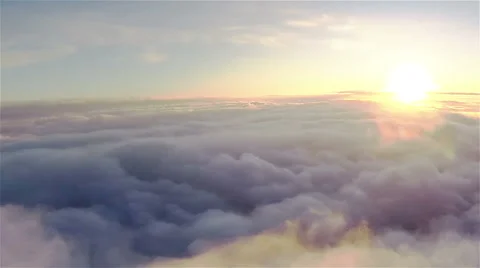 Real flight over clouds at  height of 1800 meters or 5905 ft. in sunset .Aerial  Stock Footage 59636753