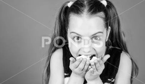 Real hunger. happy little child love sweets and treats. Healthy food and dental Stock Photos