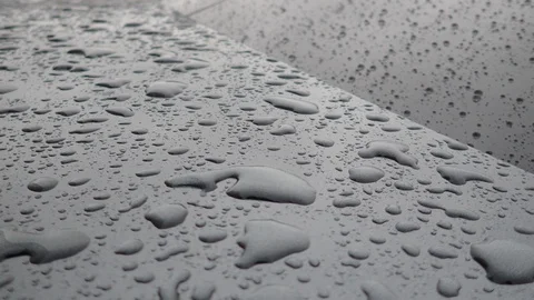 Real hydrophobic effect in the rain on a car body (Daytona grey pearl effect). Stock Footage 118925383
