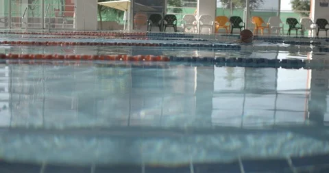 Real Life shot Super Slow motion of Female Swimmer In Indoor Swimming Pool Stock Footage