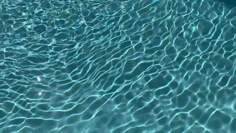 Real life view on an abstract caustic pool ripple in teal aqua color Video stock 238717141