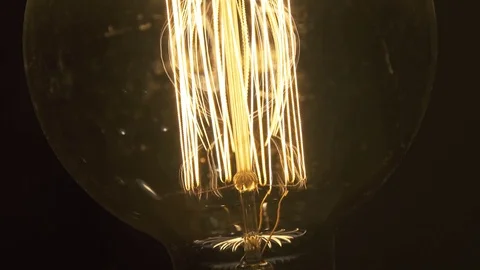 Real light bulb turning on, flickering and turning off. Macro Video stock 73392958