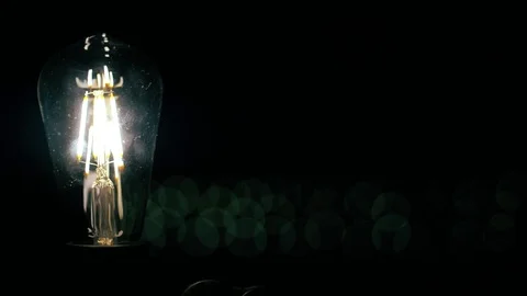 Real light bulb turning on flickering and turning off. Macro. 库存影片 79783373