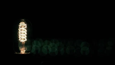 Real light bulb turning on flickering and turning off. Macro. Stock Footage 79783427