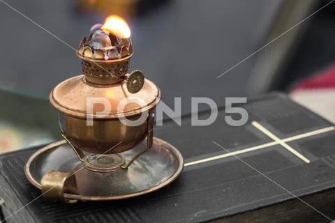 Real old oil lamp on a bible blurry background Stock Photo #167904560