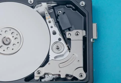 Real open computer hard drive on a blue background Stock Photos