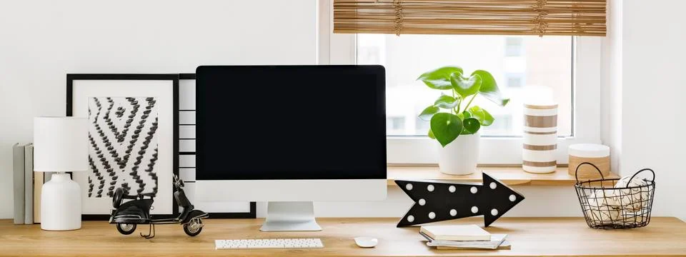 Real photo of an empty computer screen on a wooden desk in bright workspace i Stock Photos