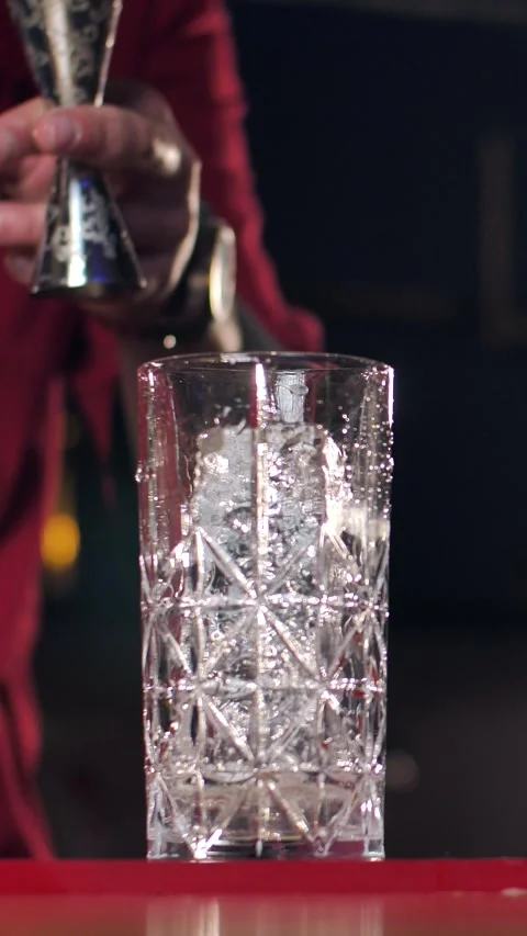 A real professional bartender creating a cocktail. Experienced bartender pouring Stock Footage 318278828