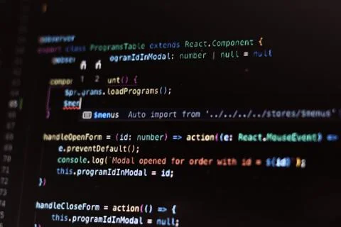 Real program code close-up. Lines of code on a dark background on a laptop sc Stock-Fotos