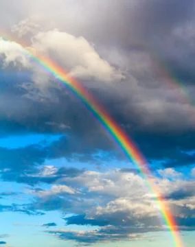 Real rainbow in the cloudy sky Stock Photos