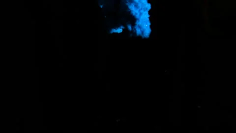 Real shot blue paint drops in water in slow motion. Ink swirling underwater Stock Footage 104931958