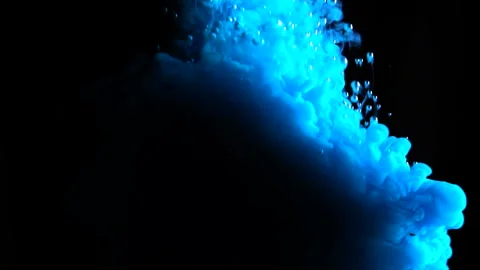 Real shot blue paint drops in water in slow motion inversion. Ink swirling Stock Footage 105155370