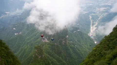 Real Shot of Cable Car Shuttling in Peak Forest Among Cloud Sea Stock Footage 337929538