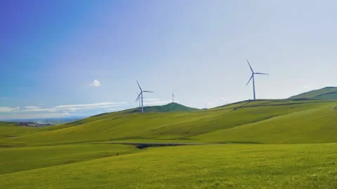 Real Shot Rolling Yellow Green Grass Slope Wind Turbine Clear Sky Drifting Cloud Stock Footage 337980909