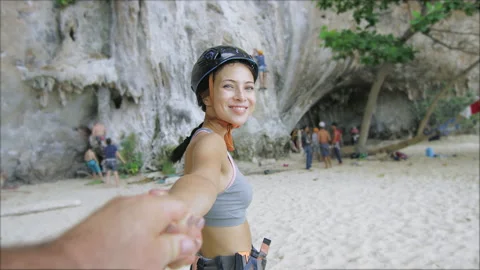 Real, slow-motion of young couple holding hands, woman leading boyfriend, walkin Stock Footage 201094504