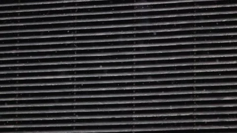 Real snow falling on on the background of the ventilation grate, Large and small Stock Footage 304272715