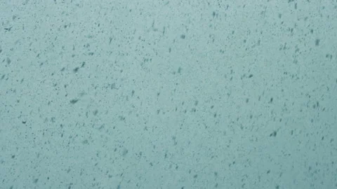 Real snowfall image on cold blue background color Stock Footage 151344576