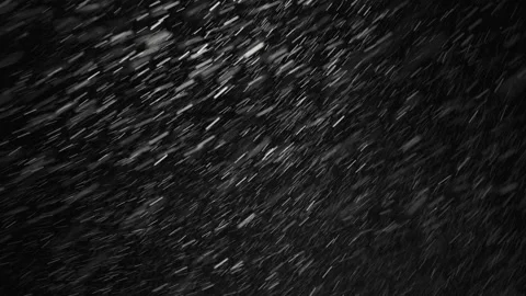 Real snowfall, winter snow with wind influence on black background. Abstract Stock Footage 148323797