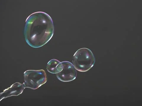 Real soap bubbles floating and moving on studio background Stock Photos