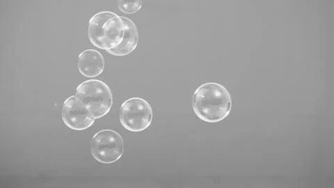 Real soap bubbles floating and moving on studio background Stock Photos