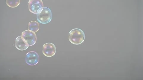 Real soap bubbles floating and moving on studio background Stock Photos