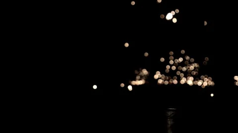 Real sparkling particles falling on ground and explode in the dark in slowmotion Stock Footage 74108849