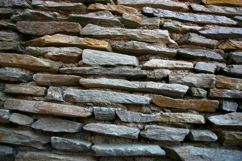 Real stone wall surface with cement Stock Photos