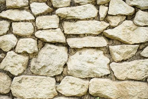 Real stone wall surface with cement, stone background. Foto stock