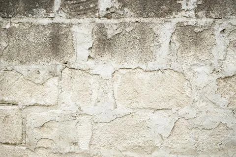 Real stone wall surface with cement, stone background. Stock Photos