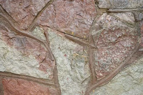 Real stone wall surface with cement, stone background. Stock Photos